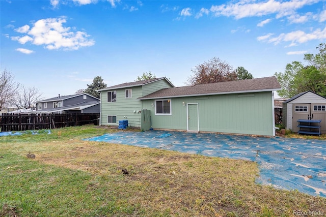 15628 E Girard Pl, Aurora, CO 80013 - rear view of property with a patio, a storage shed, an outbuilding, and roof with shingles