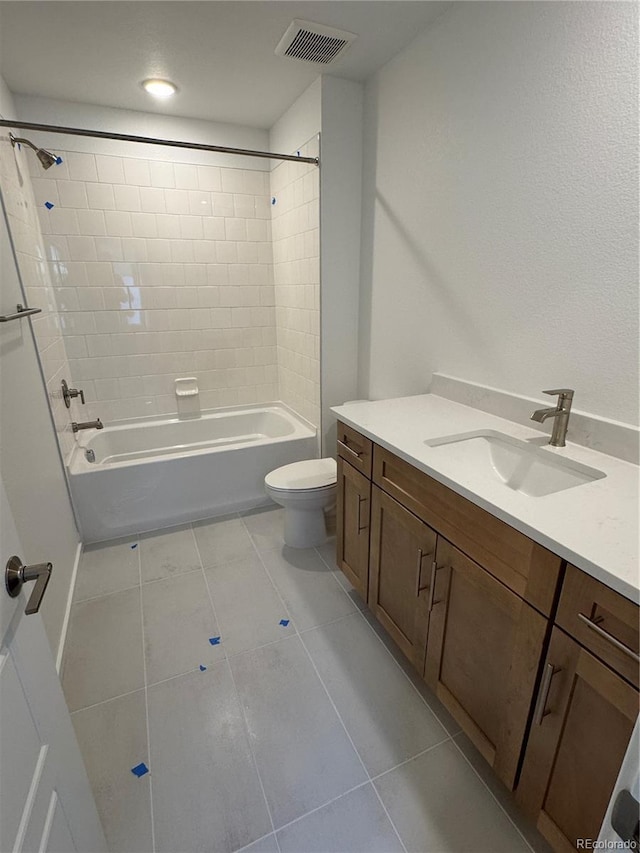 full bathroom featuring tile patterned flooring, vanity, toilet, and tiled shower / bath