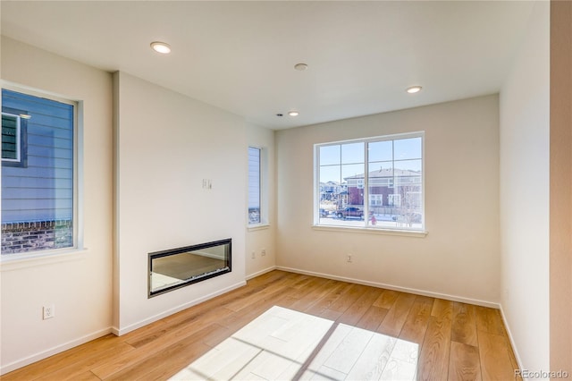 unfurnished living room with light hardwood / wood-style floors