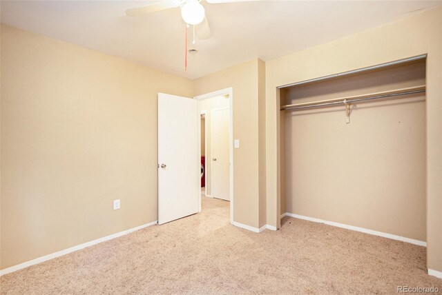 unfurnished bedroom with ceiling fan, a closet, and light carpet