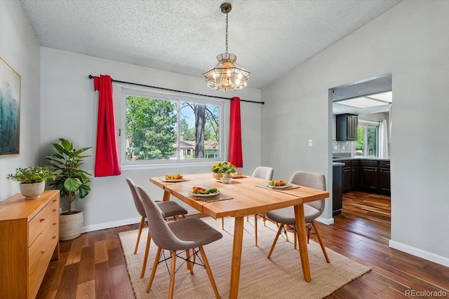 4150 Gleneagle Ct, Colorado Springs, CO 80909 - dining room featuring a chandelier, wood finished floors, a textured ceiling, vaulted ceiling, and baseboards