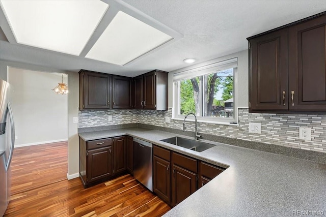 4150 Gleneagle Ct, Colorado Springs, CO 80909 - kitchen with stainless steel appliances, a sink, backsplash, dark wood-style floors, and dark brown cabinets