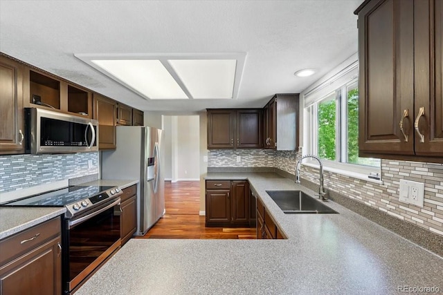 4150 Gleneagle Ct, Colorado Springs, CO 80909 - kitchen with stainless steel appliances, a sink, tasteful backsplash, and dark brown cabinets