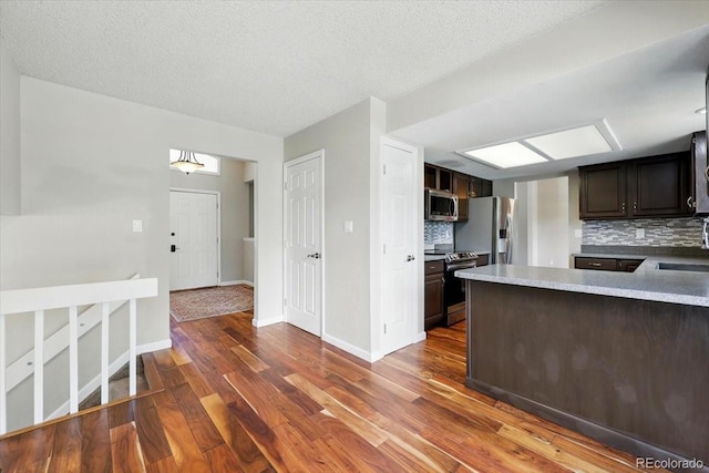 4150 Gleneagle Ct, Colorado Springs, CO 80909 - kitchen with appliances with stainless steel finishes, tasteful backsplash, and dark wood-type flooring