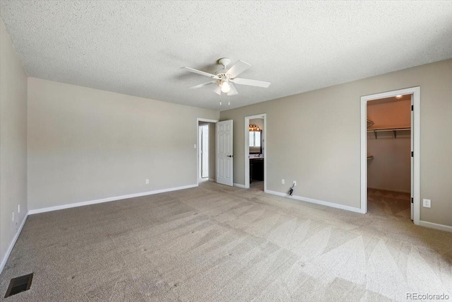 4150 Gleneagle Ct, Colorado Springs, CO 80909 - unfurnished bedroom featuring a spacious closet, carpet floors, baseboards, and a textured ceiling