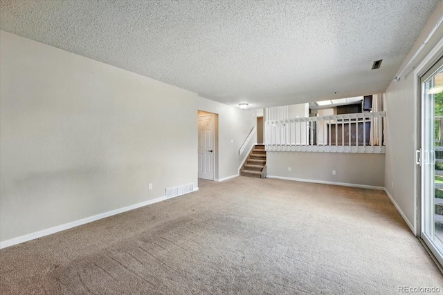 4150 Gleneagle Ct, Colorado Springs, CO 80909 - empty room featuring carpet floors, stairs, a textured ceiling, and baseboards