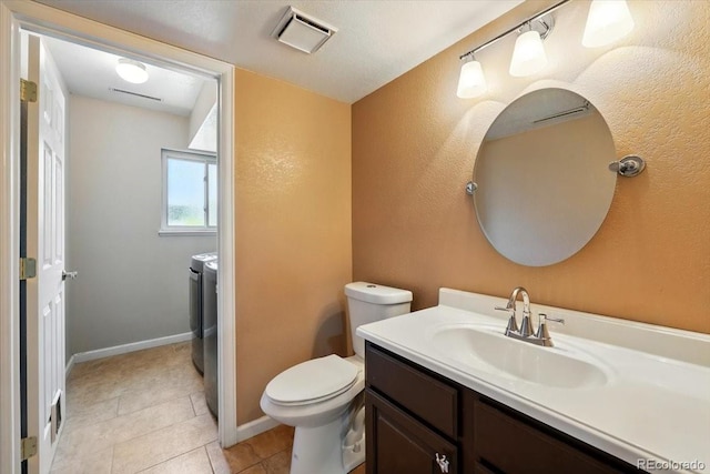 4150 Gleneagle Ct, Colorado Springs, CO 80909 - half bathroom with washer and clothes dryer, vanity, toilet, tile patterned flooring, and baseboards