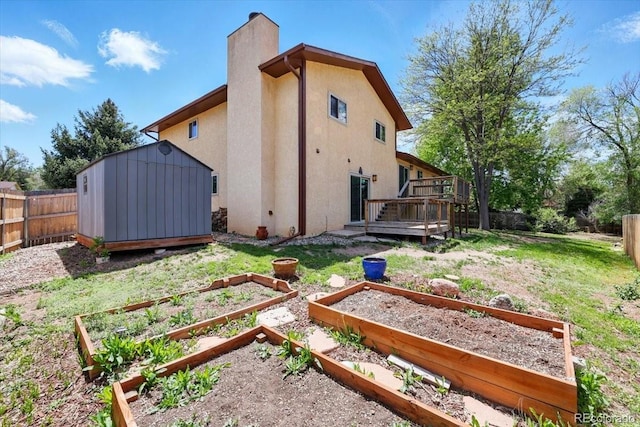 4150 Gleneagle Ct, Colorado Springs, CO 80909 - back of house with a garden, a chimney, stucco siding, and a wooden deck
