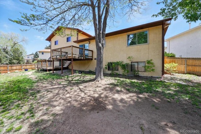 4150 Gleneagle Ct, Colorado Springs, CO 80909 - back of house with a wooden deck, stucco siding, and stairs