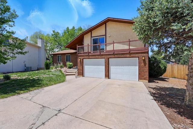 4150 Gleneagle Ct, Colorado Springs, CO 80909 - view of front of home featuring a balcony, concrete driveway, brick siding, and stucco siding