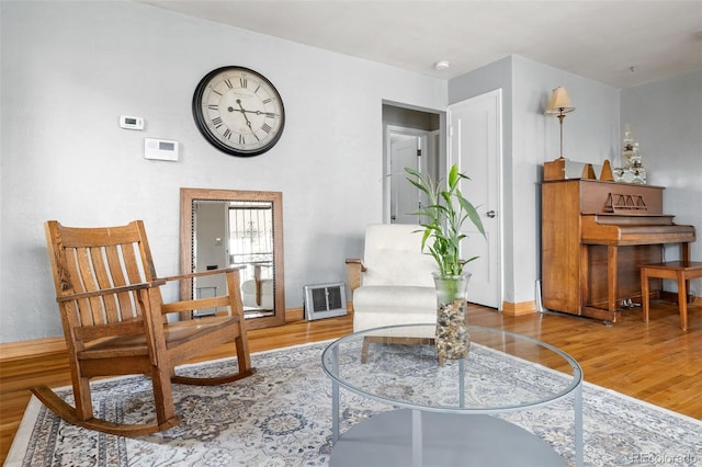 875 S Dale Ct, Denver, CO 80219 - living area featuring wood finished floors, baseboards, and heating unit