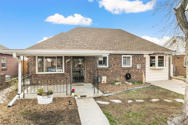 875 S Dale Ct, Denver, CO 80219 - bungalow featuring a shingled roof and brick siding