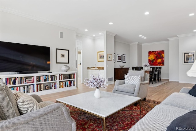 301 Garfield St Unit 1E, Denver, CO 80206 - living room featuring light wood finished floors, recessed lighting, ornamental molding, and baseboards
