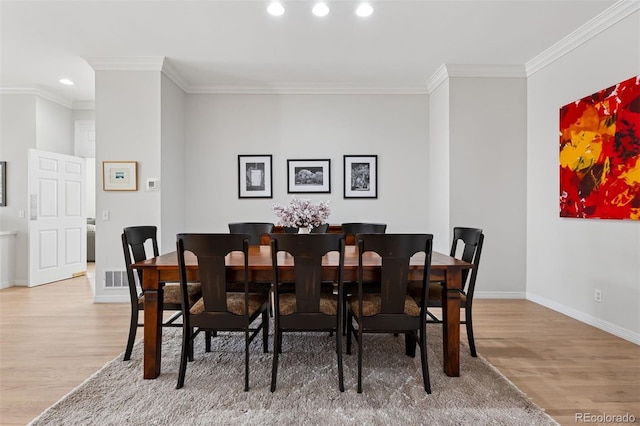 301 Garfield St Unit 1E, Denver, CO 80206 - dining area featuring light wood-style flooring, crown molding, baseboards, and recessed lighting