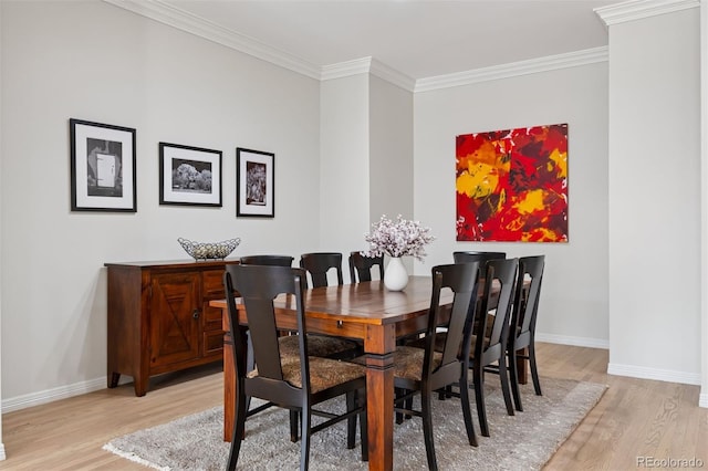 301 Garfield St Unit 1E, Denver, CO 80206 - dining space featuring light wood-style flooring, baseboards, and crown molding