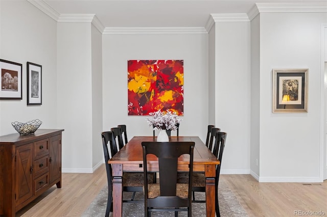 301 Garfield St Unit 1E, Denver, CO 80206 - dining room with light wood-style flooring, crown molding, and baseboards