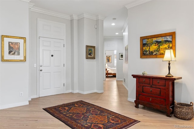 301 Garfield St Unit 1E, Denver, CO 80206 - foyer featuring light wood-style flooring, ornamental molding, and baseboards