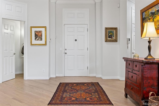 301 Garfield St Unit 1E, Denver, CO 80206 - foyer featuring light wood-style flooring, baseboards, and ornamental molding