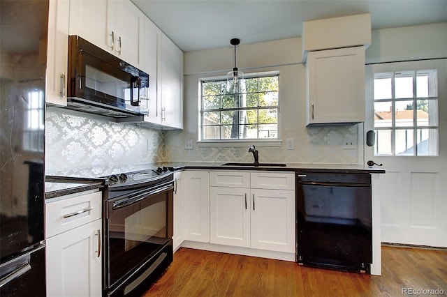 kitchen with backsplash, sink, black appliances, and white cabinetry