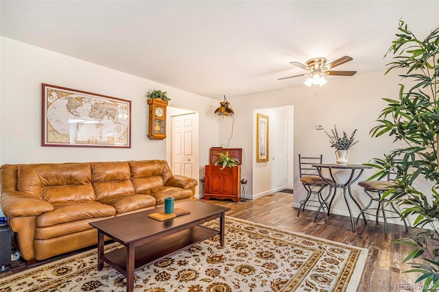 12655 E Pacific Cir Unit E, Aurora, CO 80014 - living area featuring wood finished floors, a ceiling fan, and baseboards