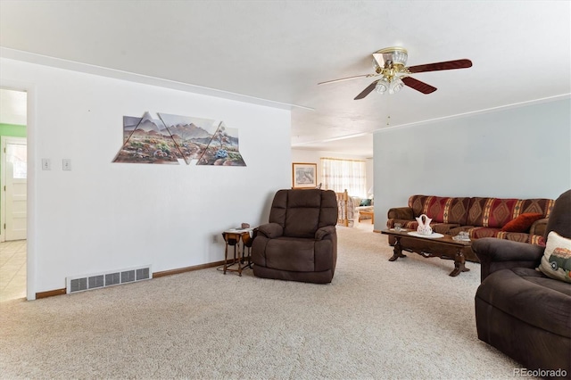 living room with ceiling fan and carpet