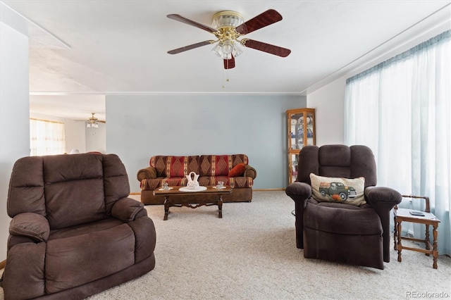 living room featuring plenty of natural light, light colored carpet, and ceiling fan