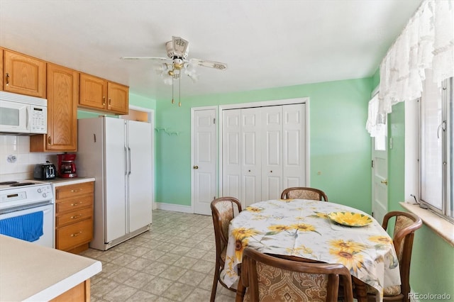 kitchen with ceiling fan, white appliances, and decorative backsplash