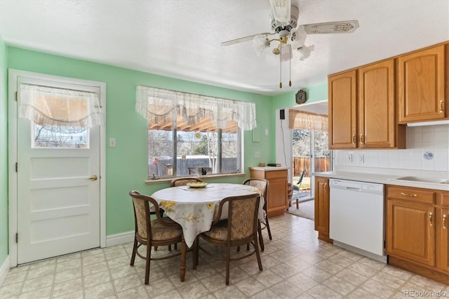 kitchen with sink, a textured ceiling, white dishwasher, ceiling fan, and backsplash