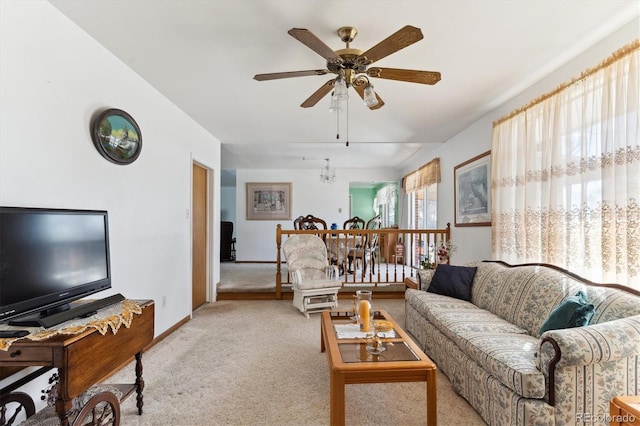 carpeted living room featuring ceiling fan