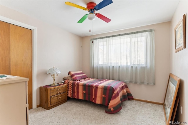 bedroom with ceiling fan and light carpet