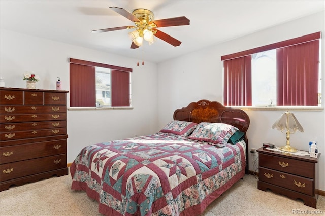 bedroom featuring light colored carpet and ceiling fan