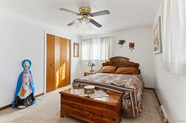 carpeted bedroom with ceiling fan, baseboard heating, and a closet