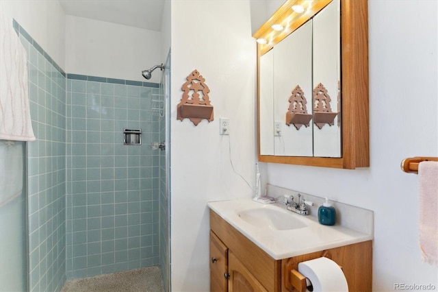 bathroom featuring vanity and a tile shower