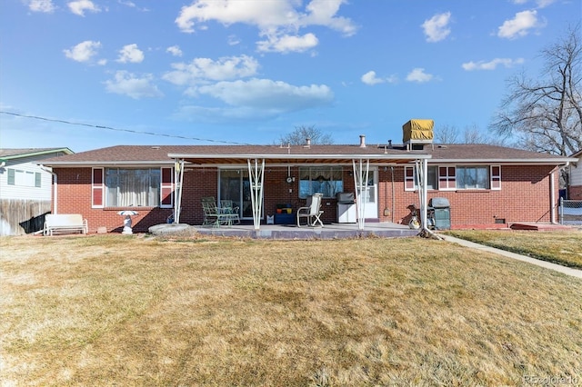 back of property featuring a patio and a yard