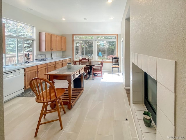 9806 Hooker Ct, Denver, CO 80031 - kitchen featuring white dishwasher, light countertops, a textured wall, recessed lighting, and lofted ceiling
