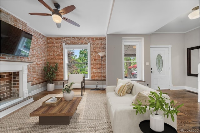 3254 Newton St, Denver, CO 80211 - living area with wood finished floors, brick wall, ceiling fan, and a fireplace with raised hearth