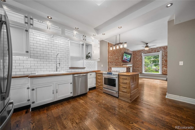3254 Newton St, Denver, CO 80211 - kitchen featuring appliances with stainless steel finishes, wooden counters, ceiling fan, backsplash, and recessed lighting