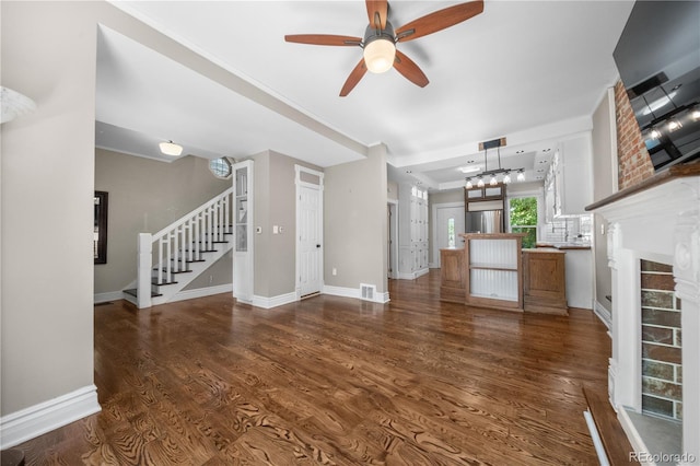 3254 Newton St, Denver, CO 80211 - unfurnished living room with stairs, wood finished floors, ceiling fan, and a chandelier