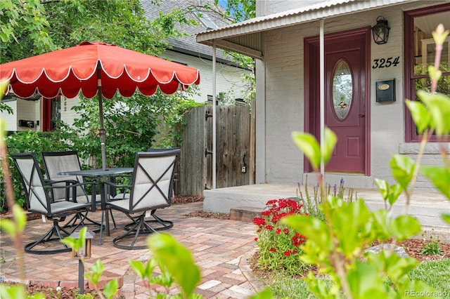 3254 Newton St, Denver, CO 80211 - view of exterior entry with outdoor dining space, brick siding, and a patio area