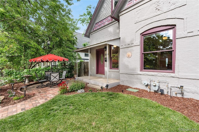 3254 Newton St, Denver, CO 80211 - view of exterior entry featuring a patio and brick siding