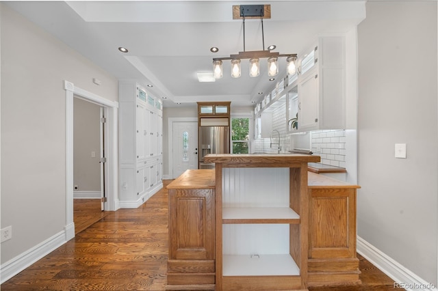 3254 Newton St, Denver, CO 80211 - kitchen featuring stainless steel refrigerator with ice dispenser, a peninsula, white cabinetry, dark wood finished floors, and recessed lighting