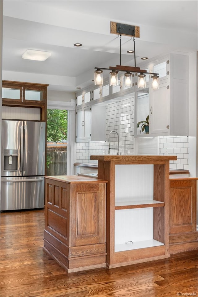 3254 Newton St, Denver, CO 80211 - kitchen featuring stainless steel refrigerator with ice dispenser, decorative backsplash, white cabinets, dark wood finished floors, and recessed lighting