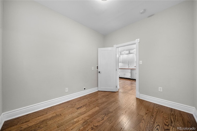 3254 Newton St, Denver, CO 80211 - spare room featuring wood finished floors, a smoke detector, and vaulted ceiling