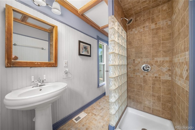 3254 Newton St, Denver, CO 80211 - bathroom featuring a tile shower and a sink