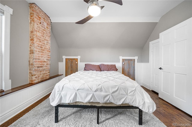3254 Newton St, Denver, CO 80211 - bedroom featuring lofted ceiling, wood finished floors, a wainscoted wall, and ceiling fan