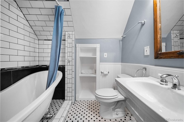 3254 Newton St, Denver, CO 80211 - bathroom featuring vaulted ceiling, a soaking tub, tiled shower, and a wainscoted wall