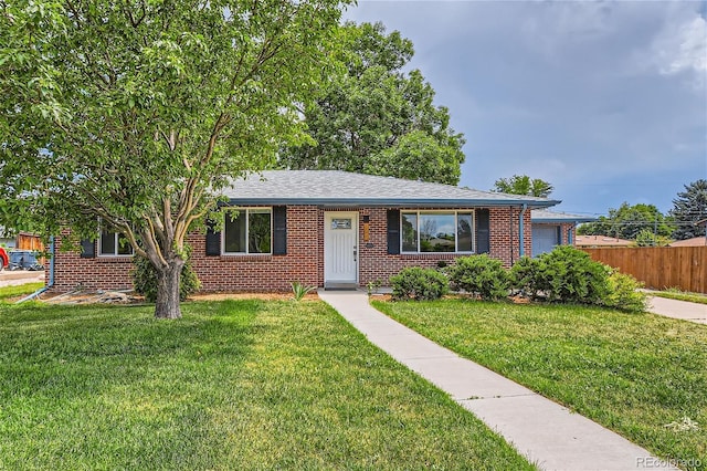 ranch-style home with a garage and a front yard