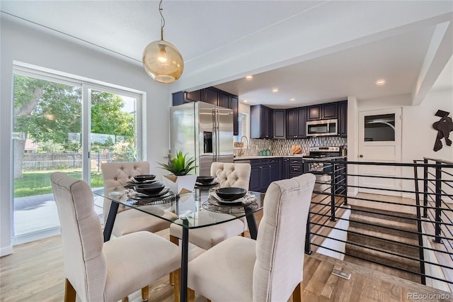 dining room with light hardwood / wood-style floors and sink