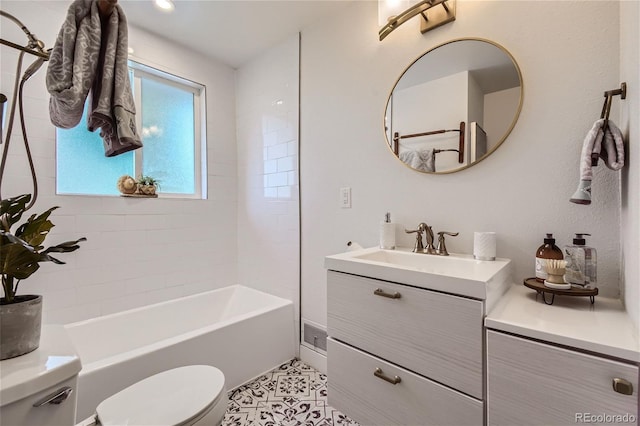 full bathroom featuring tile patterned flooring, vanity, toilet, and tiled shower / bath combo