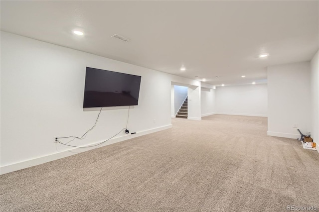 basement featuring light colored carpet